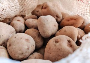 Close-up of fresh potatoes in a burlap sack, showcasing natural textures.